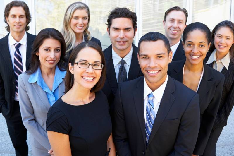 Portrait Of Business Team Outside Office Looking At Camera Smiling